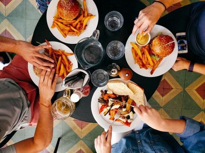 Pessoas comendo lanche em mesa