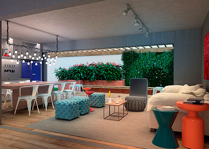 Ambiente integrado sala e cozinha espaçosa e colorida. Detalhe para as plantas ao fundo